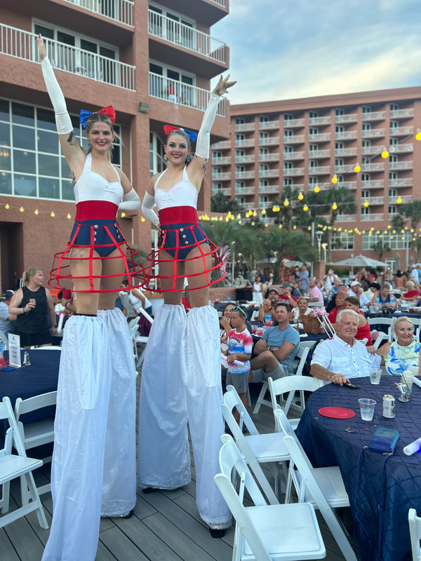 Flying with Ease entertainment silt walker performers. Stilt walkers, party performers, circus performers, entertainers, Pensacola Beach performers, Pensacola Performers, holiday performers, holiday entertainment 
