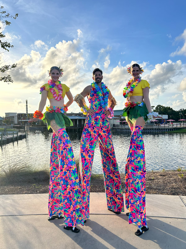 Flying with Ease entertainment stilt walkers, female stilt walker, male stilt walker, stilt walker, performers, entertainers, Pensacola performer, party performers, Hawaiian performers 